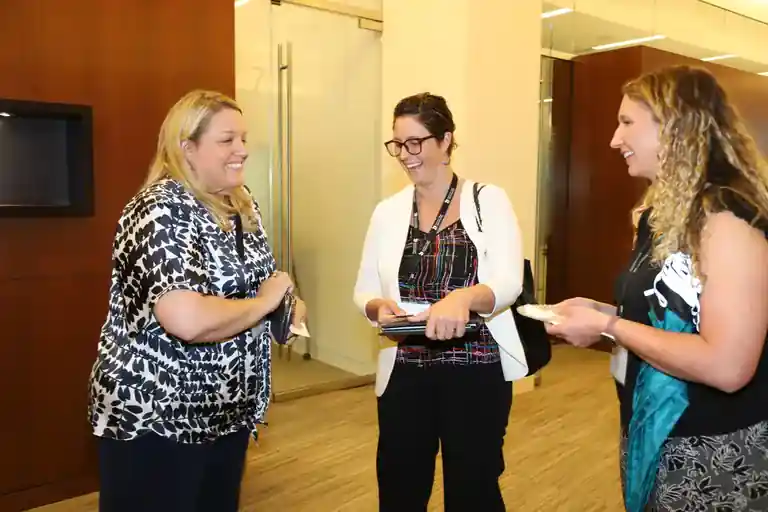 Three IoT Slam attendees sharing a conversation.