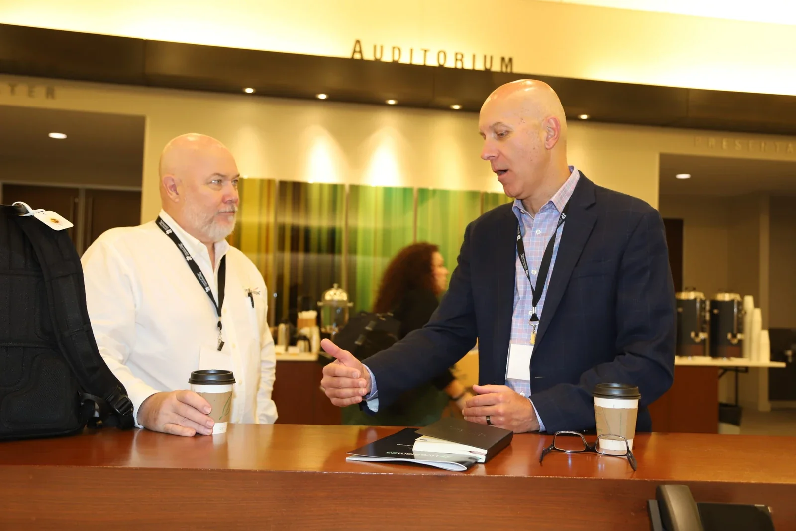 Two IoT Community attendees in conversation at a live industry event.